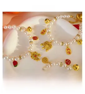 Detail of pet pearl necklace with lucky gold lock and bell pendant in Chinese style