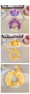 Flat lay of handmade crochet pet flower collar and rabbit ear hat in purple and yellow