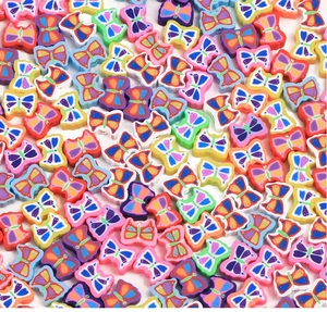 Flat lay macro of vibrant polymer clay butterfly beads for DIY jewelry making crafts