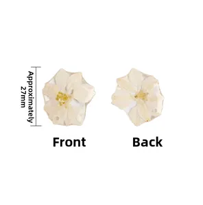 Front and back detail of 27mm resin charm with real dried white flower for DIY jewelry