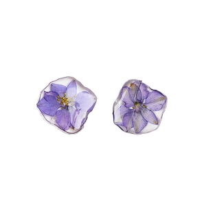 Irregular silver-edged resin earrings with purple dried delphinium flower petals