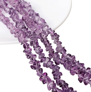 Close-up of irregular natural purple amethyst crystal chips for DIY jewelry making