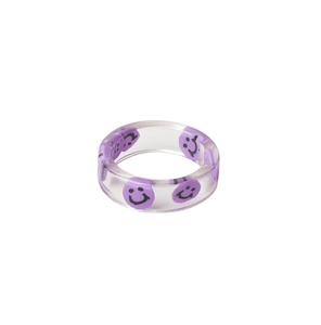 Macro shot of colorful resin ring with purple smiley face patterns in clear material