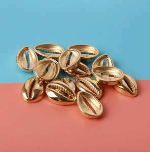Close-up of golden CCB cowrie shell beads for handmade DIY jewelry and craft making