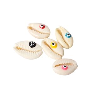 Macro shot of five natural shell beads featuring colorful evil eye patterns for DIY jewelry