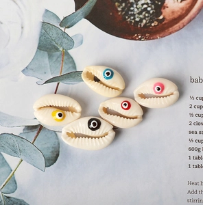 Detailed view of colorful shell evil eye beads for DIY jewelry and necklaces