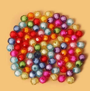 Macro shot of colorful faceted acrylic beads for DIY jewelry making and handmade crafts