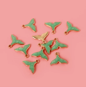 Detail of alloy whale tail pendants with green enamel for DIY jewelry making