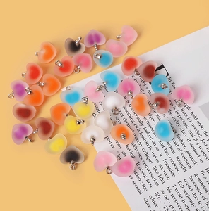 Detailed view of colorful frosted acrylic heart pendants for DIY jewelry making