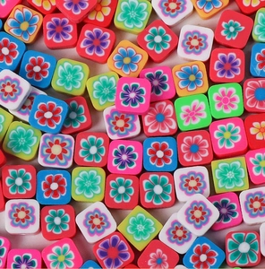 Detailed close-up of colorful floral polymer clay square beads for DIY jewelry making