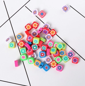 Detailed view of colorful flower pattern square polymer clay beads for DIY jewelry making