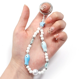 Blue and white fish-shaped ceramic beads keychain with a large pearl and silver metal clasp
