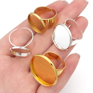 Close-up of adjustable round copper ring bases in gold and silver for DIY jewelry making