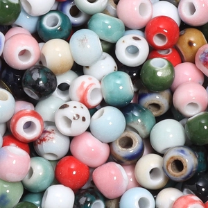 Macro shot of colorful glazed ceramic beads with large holes for DIY jewelry making