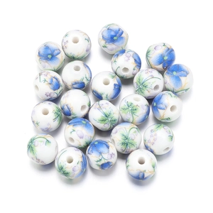 Macro detail of round ceramic beads with blue and purple floral patterns for DIY jewelry