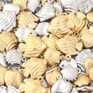 Detailed macro of gold and silver starfish and shell charms for DIY jewelry making