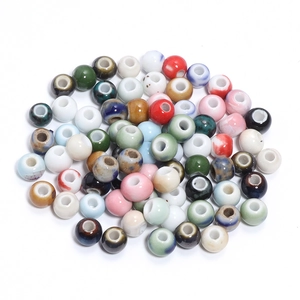 Macro shot of colorful glazed ceramic beads for DIY jewelry making with marble texture