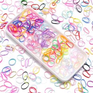 Flat lay of colorful high elasticity kids hair ties on a minimalist white tray