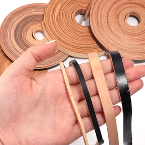 Detailed close-up of genuine flat cowhide leather cords in assorted widths and natural tones