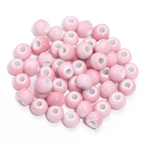 Macro shot of light pink gradient ceramic beads with smooth glazed finish for DIY jewelry