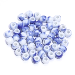 Macro shot of blue and white glazed ceramic round beads for DIY jewelry making