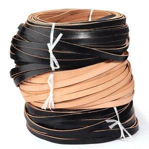 Stack of black and natural cowhide leather strips for DIY handmade leathercraft