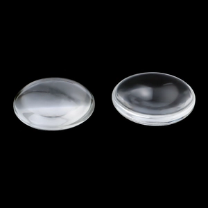 Detailed view of clear glass cabochons showing smooth rounded surface and optical transparency