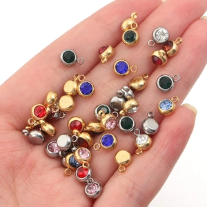 Macro detail of multi-colored birthstone charms in gold and silver finish for DIY jewelry