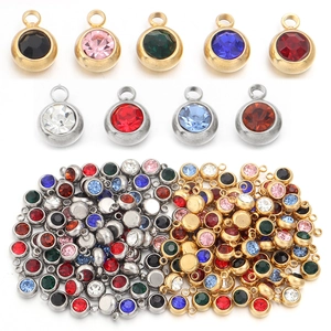 Detail of colorful birthstone pendants with gold and silver stainless steel settings