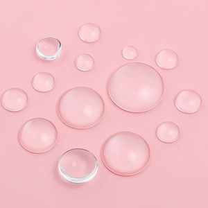 Clear glass cabochons with flat back for DIY jewelry making on pink background