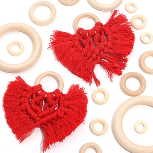 Detail of red macrame heart pendants with natural wood rings and fringed tassels
