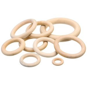 Macro detail of natural unfinished wooden rings in various sizes for DIY craft projects