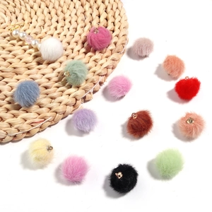 Detalle de pompones de colores de 16mm con anillos de metal dorado para joyas DIY