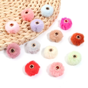 Detailed view of colorful faux rabbit fur balls with metal rings for DIY jewelry making