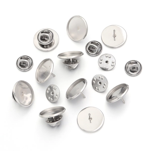 Close-up of silver stainless steel round cufflink tray bases and butterfly clutch pins