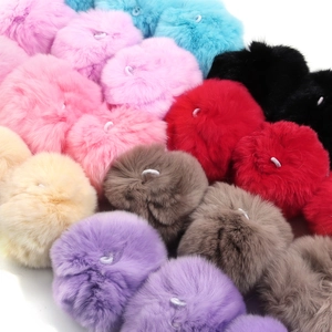 Detail view of multi-colored fluffy mink fur balls with elastic loops for DIY crafts