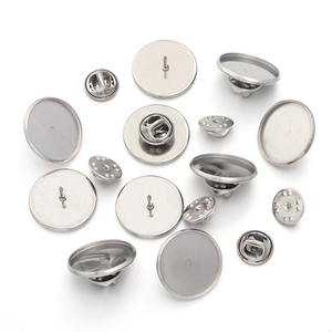 Close-up of silver stainless steel round blank brooch base with butterfly clutch pins