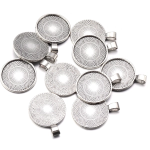 Macro view of vintage zinc alloy round pendant trays with radial texture for DIY jewelry