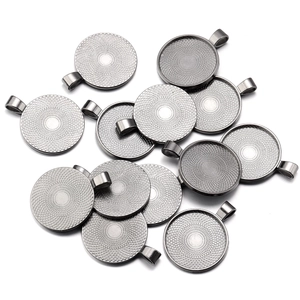 Macro detail of antique silver round alloy pendant trays with sunburst pattern textures