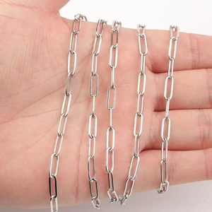 Polished silver paperclip chain link detail held in hand for necklace DIY jewelry making