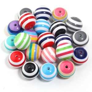 Close-up of 20mm colorful striped resin barrel beads with holes for DIY jewelry making