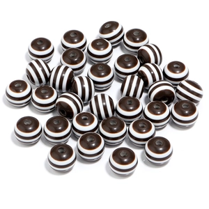Macro shot of 20mm brown striped resin beads with central holes for DIY jewelry