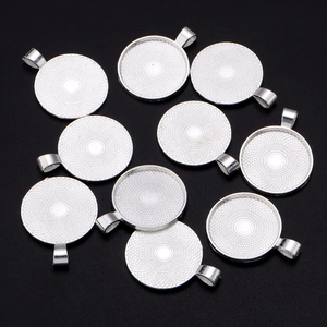 Macro shot of silver round bezel trays with textured base for DIY jewelry making