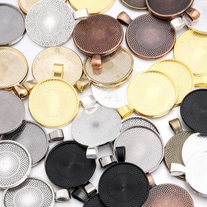 Macro shot of assorted metal alloy round pendant trays for DIY jewelry making supplies