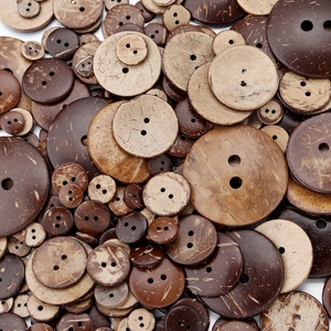 Macro shot of assorted eco-friendly coconut shell buttons with natural wood grain and textures