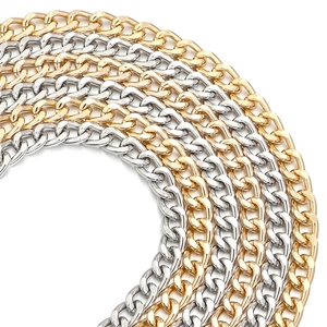 Close-up of gold and silver curb chains for bags showing heavy metal links and texture