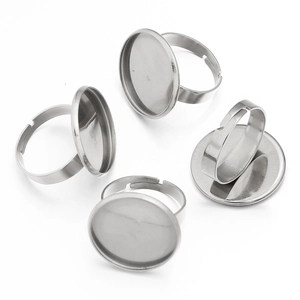 Macro view of adjustable stainless steel ring blanks with flat round setting trays for DIY