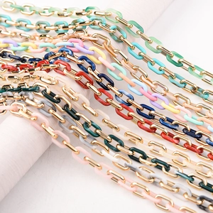 Detailed close-up of colorful acrylic link chains with polished gold metal rings