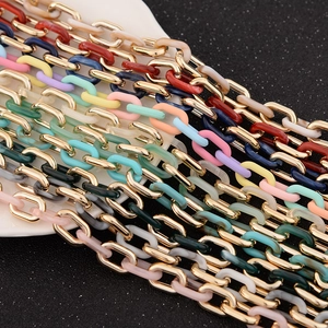 Detail of colorful acrylic links and gold metal chain connectors for DIY accessories