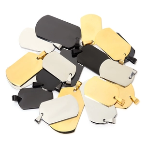 Close-up of polished stainless steel military dog tags in gold silver and black colors